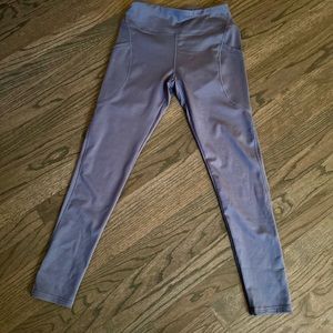 Blue workout leggings in size medium with side pockets.